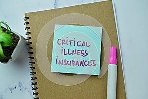 Concept of Critical Illness Insurances write on sticky notes isolated on Wooden Table