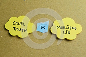 Concept of Cruel Truth vs Merciful Lie write on sticky notes isolated on Wooden Table photo