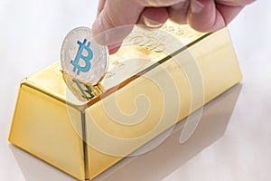 Concept of Cryptocurrency physical bitcoin with gold bullion piggy bank