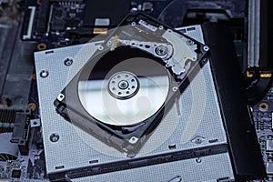 The concept of data, hardware, and information technology, the image of inside of hard disk drive on the technician`s desk and a