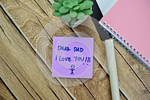 Concept of Dear Dad I Love You write on sticky notes isolated on Wooden Table