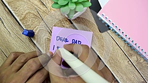 Concept of Dear Dad I Love You write on sticky notes isolated on Wooden Table