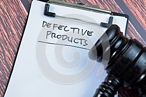 Concept of Defective Product write on paperwork with gavel isolated on wooden background
