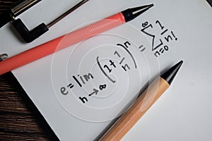 Concept of definition of the Euler's number write on book isolated on Wooden Table