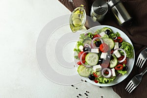 Concept of delicious food with Greek salad on white textured background