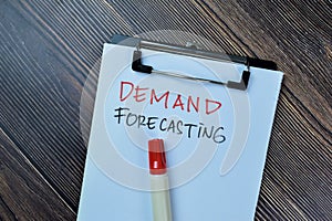 Concept of Demand Forecasting write on paperwork isolated on Wooden Table