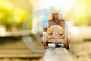 Concept design autumnal mood, yellow foliage on a background and a toy train. Fall October or November.