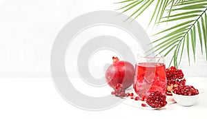 Concept of detox diet and body cleansing. Refreshing homemade lemonade cocktail with fresh pomegranates and ice.