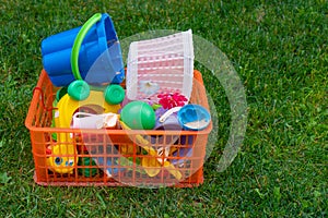 Concept of developmental game for kids. Kid toys in green grass field, Children toy box on green grass. Selective focus