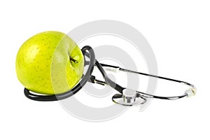 Concept for diet and healthcare - green apple and stethoscope on a white background