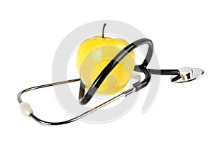 Concept for diet and healthcare - yellow apple and stethoscope on a white background