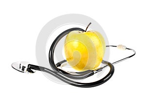 Concept for diet and healthcare - yellow apple and stethoscope on a white background