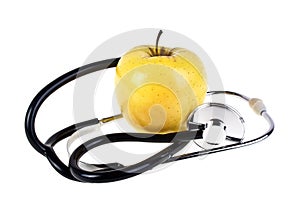 Concept for diet and healthcare - yellow apple and stetoskop on a white background photo