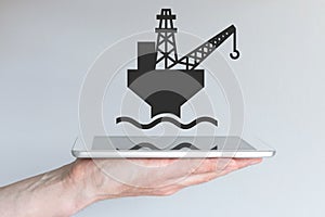Concept of digital and mobile oil and gas business. Hand holding modern smart phone