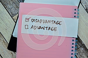 Concept of Disadvantage write on sticky notes isolated on Wooden Table