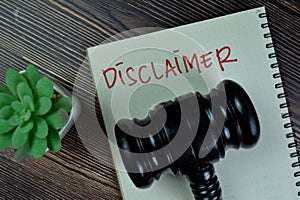 Concept of Disclaimer write on a book isolated on Wooden Table