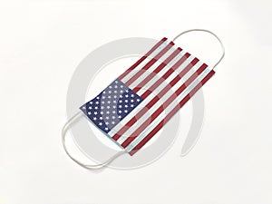 Concept. Disposable medical surgical face mask with USA United States of Amercia country flag superimposed on it, on white backgro photo