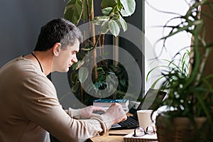 The concept of distance work or online learning during the quarantine virus. Young man working on digital laptop at home