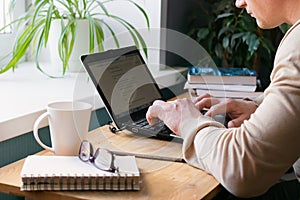 The concept of distance work or online learning during the quarantine virus. Young man working on digital laptop at home