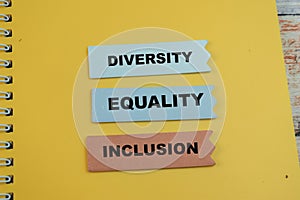 Concept of Diversity, Equality, Inclusion write on sticky notes isolated on Wooden Table