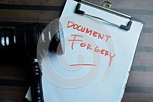 Concept of Document Forgery write on paperwork isolated on wooden background photo