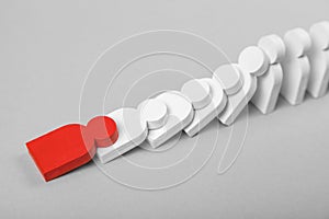 Concept of domino effect in business. The fall of the crumbling business starts with one bad employee leader