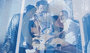 Concept of double exposure.Team coworkers making great work discussion in modern office.Business people working process