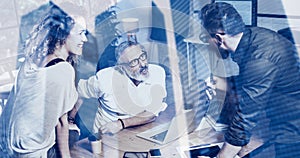 Concept of double exposure.Young team coworkers making great work discussion in modern office.Bearded man talking wit