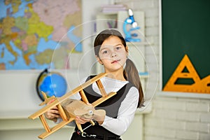 Concept of dreams and travels. back to school. stem. want to travel. small girl play with toy airplane. Child pilot