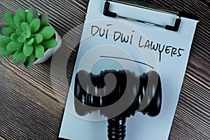 Concept of Dui Dwi Lawyers write on paperwork with gavel isolated on Wooden Table