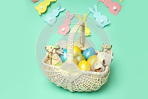 Concept of Easter eggs on mint background