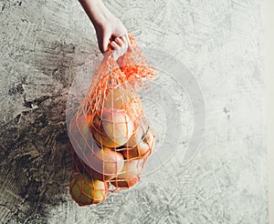 Concept-ecology, nature conservation, no plastic bags. Reusable mesh bag with apples, copy space