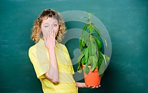 Concept ecology. teacher woman in glasses at biology lesson. student girl with plant at blackboard. environmental