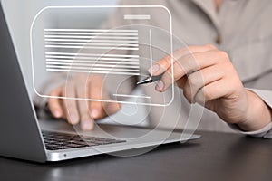 Concept of electronic signature. Woman working on laptop at table indoors, closeup