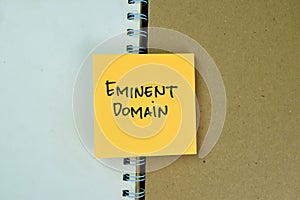 Concept of Eminent Domain write on sticky notes isolated on Wooden Table photo