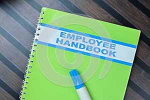 Concept of Employee Handbook write on book isolated on Wooden Table