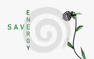 The concept energy save. Black electric plug with green leaves on a white background