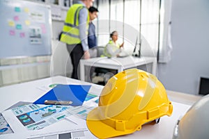 Concept of engineering meeting with protective helmet for competent engineer.