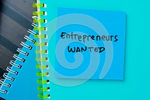 Concept of Entrepreneurs Wanted write on sticky notes isolated on Wooden Table