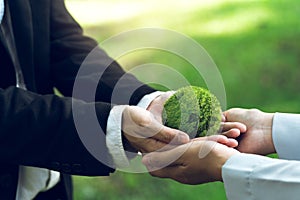 Concept of the Environment World Earth Day. Hands holding green earth, Saving environment, and environmentally sustainable