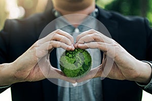 Concept of the Environment World Earth Day. Hands holding green earth, Saving environment, and environmentally sustainable