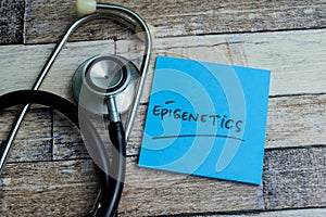 Concept of Epigenetics write on sticky notes isolated on Wooden Table photo