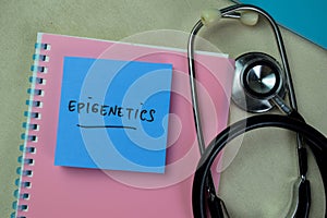 Concept of Epigenetics write on sticky notes with stethoscope isolated on Wooden Table photo
