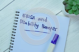 Concept of ERISA and Disability Benefits write on book isolated on Wooden Table photo