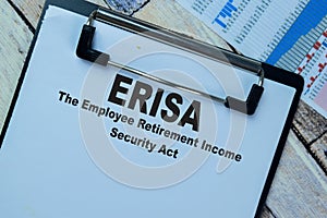 Concept of ERISA - The Employee Retirement Income Security Act write on paperwork isolated on Wooden Table