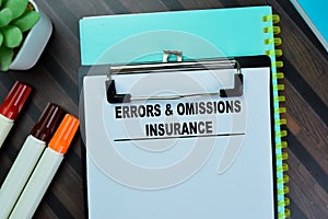 Concept of Errors & Omissions Insurance write on paperwork isolated on Wooden Table