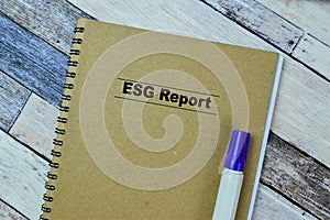 Concept of ESG Report write on book isolated on Wooden Table