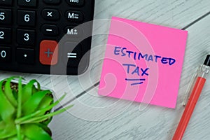 Concept of Estimated Tax write on sticky notes isolated on Wooden Table