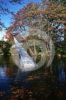 Concept of eternity and infinity. Stairs sculpture with pointy apex entitled Diminish and Ascend escalating from water to air