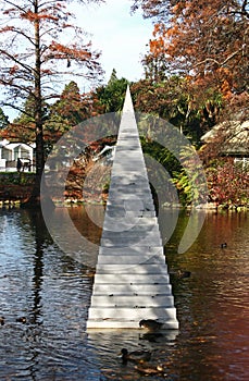 Concept of eternity and infinity. Stairs sculpture with sharp point entitled Diminish and Ascend ascending from water to air